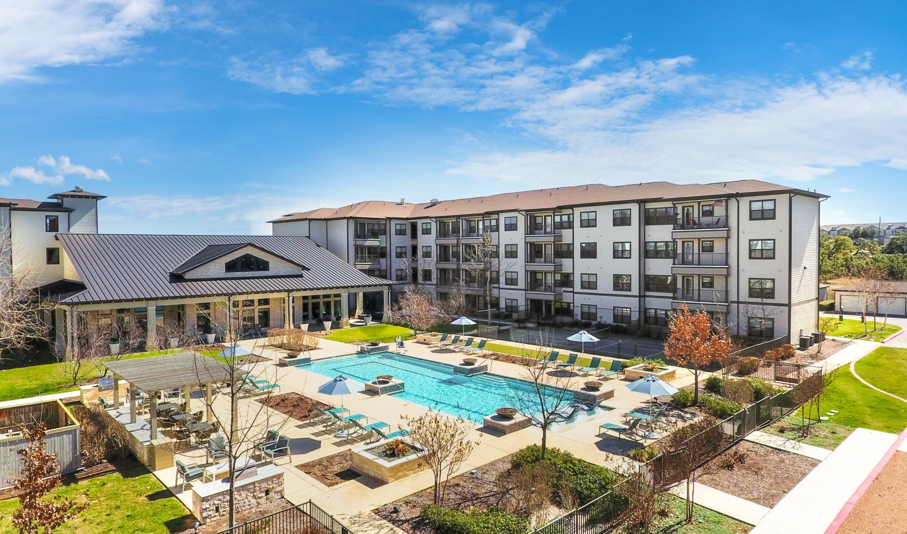 a large building with a pool in front of it