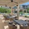 a patio with tables and chairs by a pool