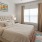 a bedroom with a fan and a bed and a window