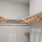 a walk in closet with hangers and shelves