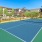 a tennis court in front of a building